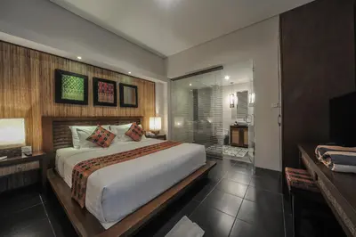 a bedroom with a large bed and a television at Gaing Mas Jimbaran Villas by Gaing Mas Group in Jimbaran