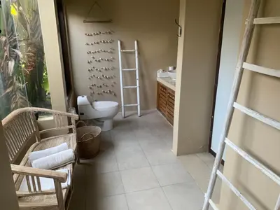 a bathroom with a toilet and a sink at La Dolce Villa in Seminyak