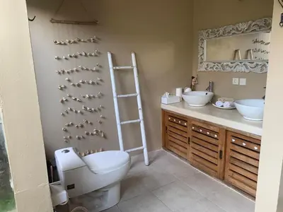 a bathroom with a toilet and two sinks at La Dolce Villa in Seminyak