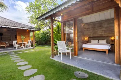 a bedroom in a villa with a bed and a patio at Villa Du Bah - Cozy Tropical 3BR Villa 12min To Beach in Kerobokan