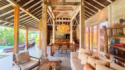 an open living room with a table and chairs at Villa Du Bah - Cozy Tropical 3BR Villa 12min To Beach in Kerobokan