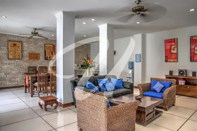 a living room with a couch and a table at Vila Ultima Bali in Seminyak