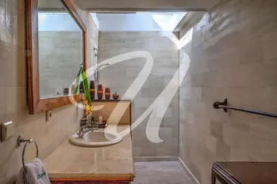 a bathroom with a sink and a mirror at Vila Ultima Bali in Seminyak
