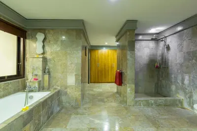 a large bathroom with a tub and a shower at Villa Kibbi in Seminyak