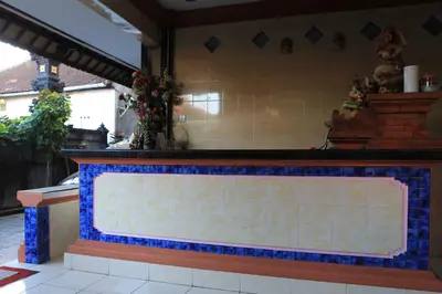 a kitchen with a blue and white counter top at Losmen Cempaka 3 in Kuta