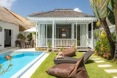 a backyard with a swimming pool and a house at Villa Blue Pearl by Optimum Bali Villas in Seminyak