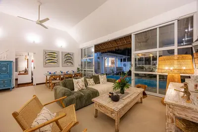 a living room with a couch and a table at Villa Blue Pearl by Optimum Bali Villas in Seminyak