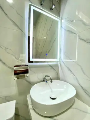 a bathroom with a white sink and a mirror at Wita Homestay Berawa in Canggu