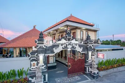 a house with a gate in front of it at Wita Homestay Berawa in Canggu