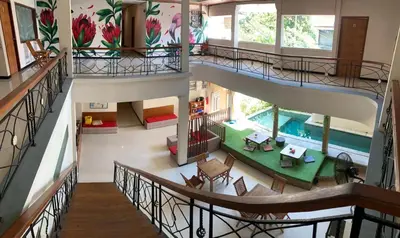 an overhead view of a house with a swimming pool at Kuta Suci Guesthouse in Kuta