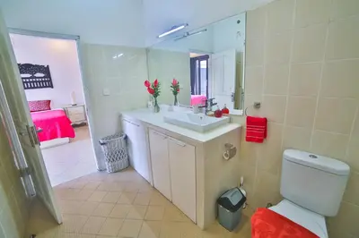 a bathroom with a toilet and a sink and a mirror at Bali Cinta Villa in Seminyak