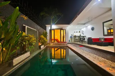 a house with a swimming pool in a living room at Bali Cinta Villa in Seminyak