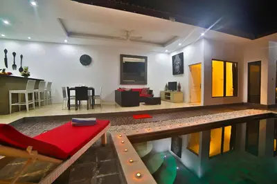 a living room with a pool in the middle of a house at Bali Cinta Villa in Seminyak