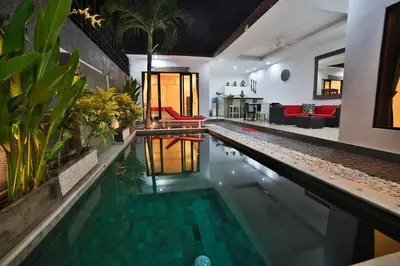 a swimming pool in the middle of a house at Bali Cinta Villa in Seminyak