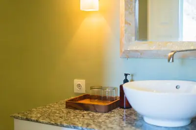 a bathroom with a sink and a mirror on a counter at Room Sweet Room - Seminyak Center, walk to the Beach in Seminyak