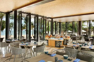 a rendering of a restaurant with tables and chairs at The Anvaya Beach Resort Bali in Kuta