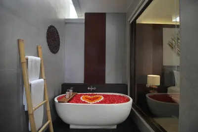 a bathroom with a bath tub with a heart painted on it at Sudha Villa Bali Baik-Baik in Seminyak