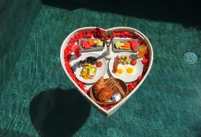 a heart shaped plate of food in the shape of a heart at Sudha Villa Bali Baik-Baik in Seminyak