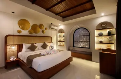 a bedroom with a large bed and a window at Sudha Villa Bali Anyelir in Seminyak