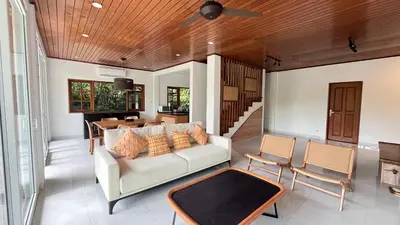 a living room with a couch and a table at Baliana Villa Legian in Legian