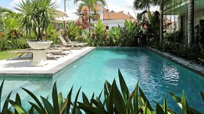 a swimming pool in the backyard of a house at Indah Homestay in Seminyak
