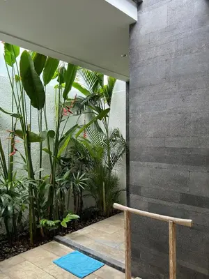 a room with plants and a blue yoga mat at Aster Villa Seminyak in Seminyak