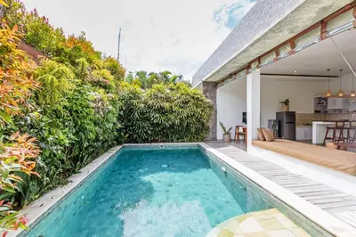 an infinity pool in the backyard of a house at Adorable 1BR villas in the heart of Seminyak in Seminyak
