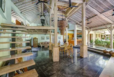 a large living room with wooden ceilings and a dining room at Villa Cinta Damai - Stunning & Stylish 4BR Luxury Villa in the Heart of Seminyak, Just a 10-Min Walk to the Beach in Seminyak