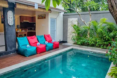 a patio with colorful furniture next to a swimming pool at Villa Sedana, Seminyak - 2 Bedroom Private Pool Villa! in Seminyak
