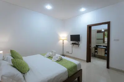 a bedroom with a bed and a television in it at Villa Sedana, Seminyak - 2 Bedroom Private Pool Villa! in Seminyak