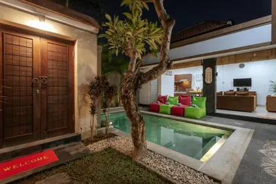 a house with a pool and a tree in the yard at Villa Sedana, Seminyak - 2 Bedroom Private Pool Villa! in Seminyak