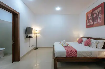 a bedroom with a bed with a tv on the wall at Villa Sedana, Seminyak - 2 Bedroom Private Pool Villa! in Seminyak