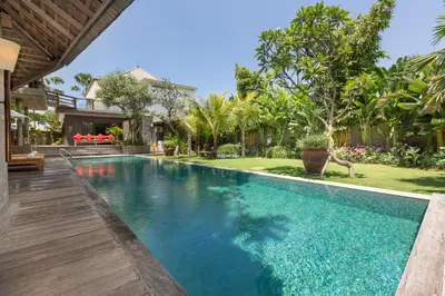 a swimming pool in a villa with a yard at Jadine Bali Villa by Nagisa Bali in Canggu