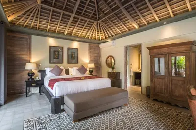 a bedroom with a large bed and a wooden ceiling at Jadine Bali Villa by Nagisa Bali in Canggu
