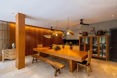 a dining room with a wooden table and chairs at Jadine Bali Villa by Nagisa Bali in Canggu
