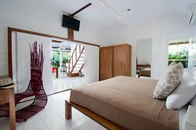 a bedroom with a bed and a table and a chair at 3BR Villa Hari - Special Stay Bonus - Minggu Villas Seminyak in Seminyak