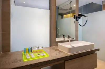 a bathroom with a sink and a mirror at Solia Legian Bali in Legian