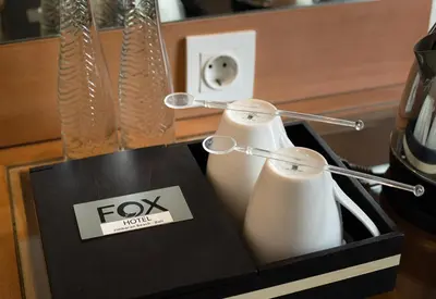 a box with two white bottles and a sign on it at FOX Hotel Jimbaran Beach Bali in Jimbaran