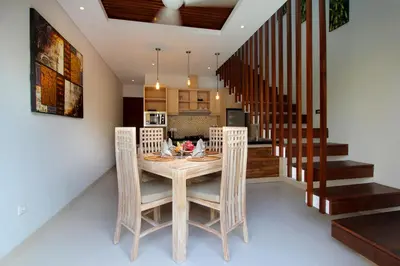 a kitchen and dining room with a table and chairs at The Murdha Villa in Seminyak