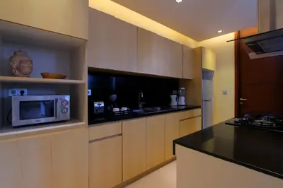 a kitchen with a microwave and a counter top at The Murdha Villa in Seminyak