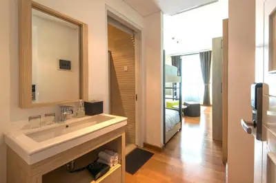 a bathroom with a sink and a mirror at Yan's House Hotel in Kuta