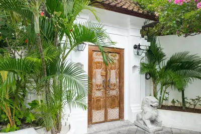 a door with a statue in front of a house at Ocean Star 5 in Seminyak