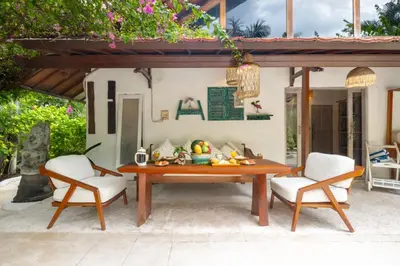 a wooden table and two chairs on a patio at Ocean Star 5 in Seminyak