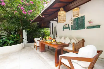a patio with a wooden table and chairs at Ocean Star 5 in Seminyak