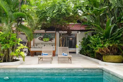 a villa with a swimming pool and a resort at Ocean Star 5 in Seminyak