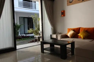 a living room with a couch and a coffee table at The Diana Suite in Kuta