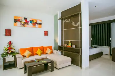 a living room with a couch and a table at The Diana Suite in Kuta