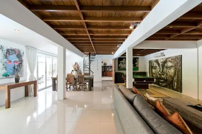 a living room with a couch and a pool table at Grange Villa - Legian in Legian