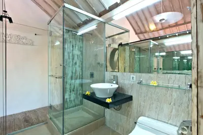 a bathroom with a glass shower and a sink at Grange Villa - Legian in Legian