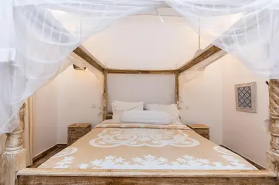 a bedroom in a house with a bed in it at Villa Kamboja Younger in Seminyak